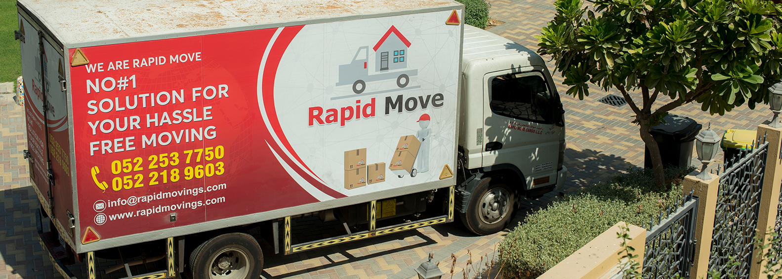 A moving truck of Rapid Rapid Move, parking in the porch in Dubai.